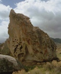 The Northenmost of the "Backyard Boulders".  The pocketed features on the left of this face is called "tifoni" (sp?...rhymes with bologna).  It's cool to look at, but off-limits to climbing under the Climbing Management Plan.  You don't want to climb it anyway, it's very gritty and loose.