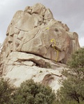 This formation is un-named, but is marked on the Castle Rock entrance Kiosk as "BLM Highpoint".  

The route shown is "The Rising", 5.13a, ending at a stance above the roof.  The entire crack all the way to the bolts is currently an aid route named "Dad Blaster", first climbed by Brad Schilling.  The final section that hasn't been freed is basically a steeper, thinner version of the "Green A" and should go at around 5.11.