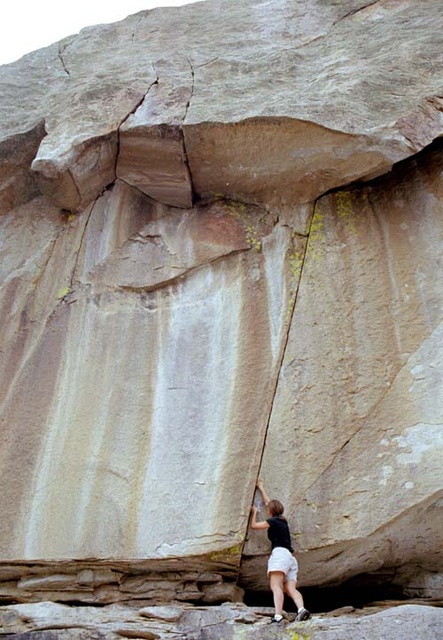 Janelle at the base of "The Rising".  The route goes up the crack to the roof, traverses left to the toe, then over the roof to a no hands rest at a little ledge.  