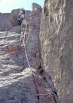 Rob climbing pitch 3.  He should have traversed right, into the dihedral about 10 feet below where he is now.  Instead he did a tension traverse from over that roof to get back on route.  